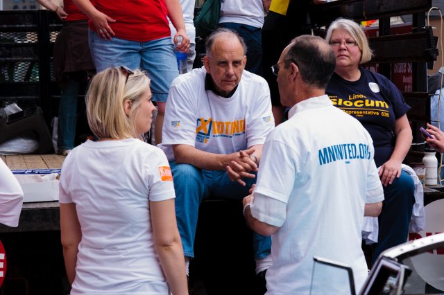 Rep. Joe Mullery, Rep. Linda Slocum, Rep. Carly Melin, and Rep. Tim Mahoney talk before the start of the Twin Cities Pride Parade.